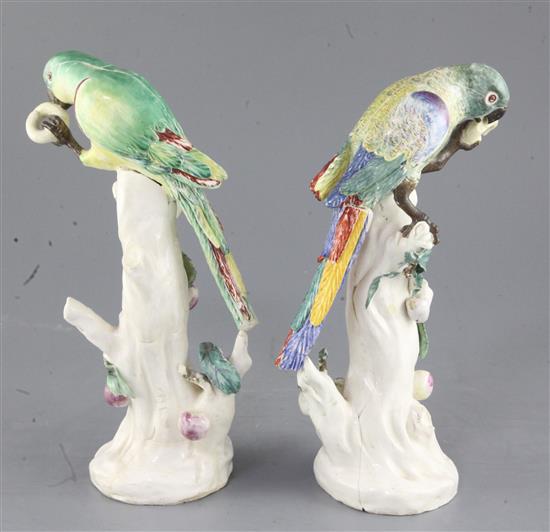 A rare pair of Naples Real Fabbrica porcelain figures of parrots on fruiting branches, early 19th century, height 26.5cm and 27cm, exte